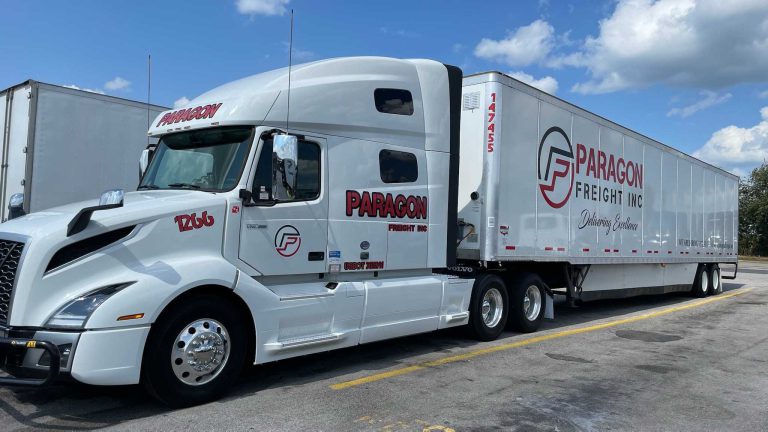 Paragon Freight blue Volvo truck number 1206 with branded dry van trailer